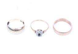 Three gold rings including an early 20th century rose gold broad band ring. Unmarked, 5.