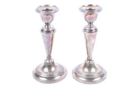 A pair of silver round candlesticks.