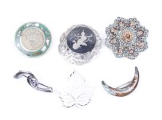 Six lady's silver and white metal brooches. One modelled as a crescent, a leaf, etc.