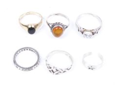 Six lady's rings. Including a gold plated onyx ring, a white metal ring with a cabochon amber, etc.