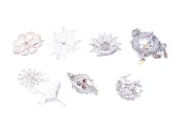 Seven lady's white metal filigree brooches.
