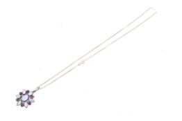 A 9ct gold, moonstone and garnet cluster pendant.