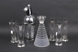 A mid-century glass cocktail set and a soda syphon.