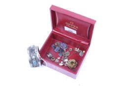 A collection of jewellery including an Egyptian broad torque bangle.