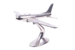 Chrome desk model of WWII B17 Flying Fortress aeroplane. Made in solid aluminium, raised on a stand.