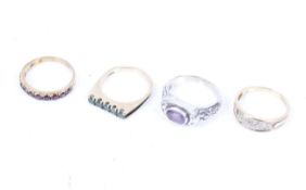 Three vintage 9ct gold and gem set rings and a white metal and amethyst single stone ring.