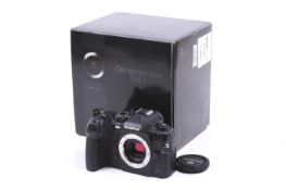 An Olympus OM-1 Digital Mirrorless camera body.