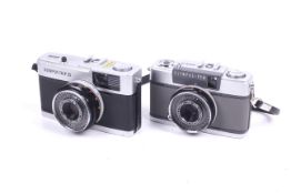 Two Olympus 35mm viewfinder cameras.