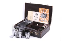 A Plaubel Makina II-S strut-folding rangefinder camera outfit.