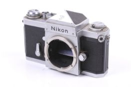 A Nikon F 35mm SLR camera body. Chrome. Serial no. 6859135. With eye level view finder.