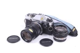 An Olympus OM10 35mm SLR camera outfit. With two lenses; an Olympus 50mm f1.