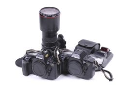 Two Canon EOS 35mm SLR cameras and a lens.