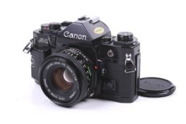 A Canon A1 35mm SLR camera. Black, serial number 1451362. With a Canon FD 50mm f1.8 lens.