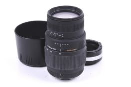 A Sigma DG 70-300mm f4-5.6 auto focus macro lens. Nikon mount. With lens hood and adaptor.