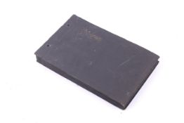 An early 20th century photograph album containing mostly small silver gelatin prints.