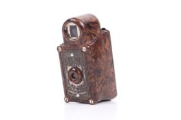 A Coronet Midget sub-miniature 16mm camera. Brown Bakelite. Shutter working.