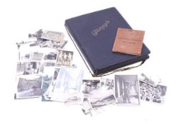 A collection of silver gelitin prints of Hong Kong from the 1950s in a blue bound album and loose.