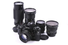 A Canon A1 35mm SLR camera outfit. With five lenses; a Canon FD 20mm f2.