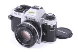 A Nikon FG-20 35mm SLR camera. Chrome. With a Nikon 50mm f1.
