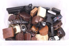 A large collection of photographic exposure meters and other accessories.