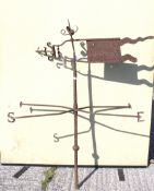 An antique wrought iron weather vane.