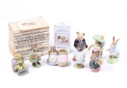 A collection of nine assorted Beatrix Potter figures and books.