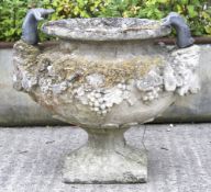 An attractively weathered reconstituted stone urn in Neo-classical style.