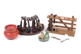 A collection of assorted smoker's pipes with stands, etc. Max.