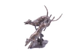 A contemporary bronze greyhound figure group. Of a pair of greyhounds jumping a fence.