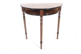 A mahogany, yew veneered and line inlaid demi-lune side table.