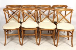 A set of eight contemporary wooden cross back dining chairs.