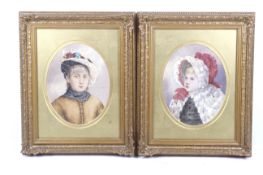 A pair of early 20th century oval watercolour portraits.