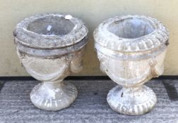 A pair of reconstituted stone garden urns.