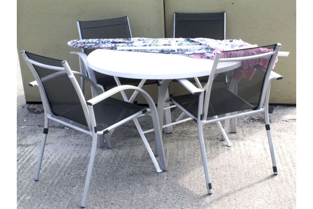 A set of four garden chairs, a circular table and a parasol.