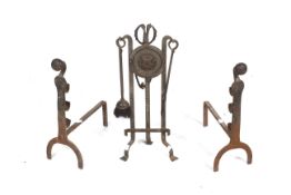 A pair of Victorian wraught iron fire dogs and companion set. Max.