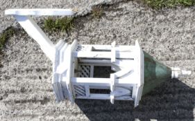 A weathered white-painted wood and copper mounted octagonal dovecote or bird house.