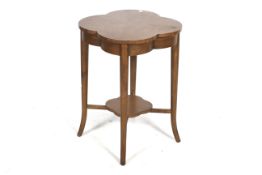 A 20th century mahogany quatrefoil shaped top side table. Turned tapering support united by a shelf.