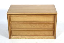A contemporary blonde oak chest of drawers. Of three long drawers.