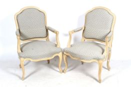 A pair of limed oak armchairs.