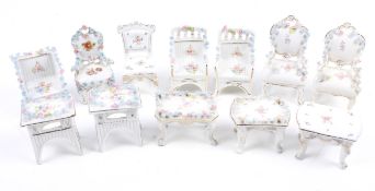 An assortment of dolls house furniture.