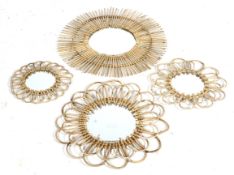 A group of four circular wall mirrors. By Two's Company framed in bamboo.