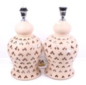 A pair of contemporary pink ceramic table lamps.