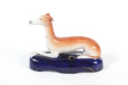 A Victorian Staffordshire greyhound pen holder.