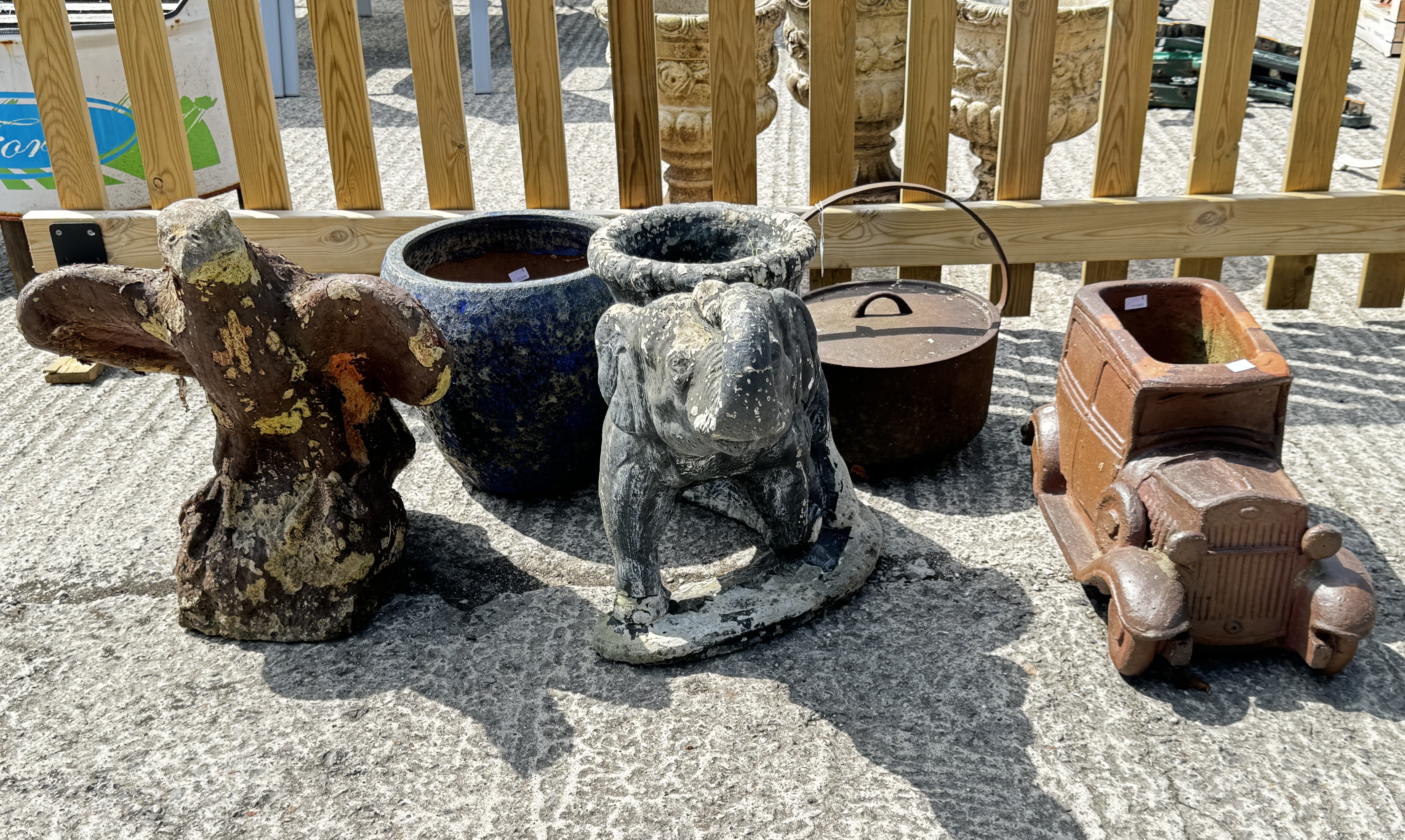 Three garden ornaments, a plant pot and a cauldron.