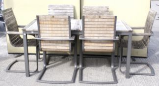 A garden table and chairs set. A rectangular teak top table with six (4+2) canterlever chairs.