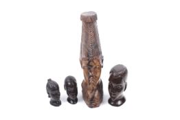 Four vintage carved wood African heads.
