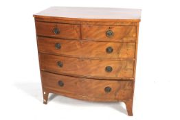 A mahogany veneered bow fronted chest of drawers.
