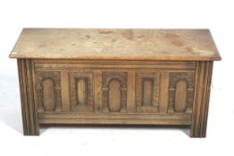 A Gothic style carved oak coffer. With five panels to the front and square reeded supports.