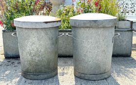 A pair of round galvanised metal bins. With handles and complete with lids, H70cm.