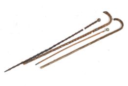 A group of three walking canes and a Somerset Light Infantry swagger stick.